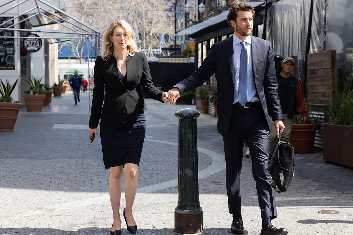 Elizabeth Holmes, founder of Theranos Inc., left, departs federal court with her partner Billy Evans in San Jose, California, US, on March 17, 2023. Photographer: Benjamin Fanjoy/Bloomberg