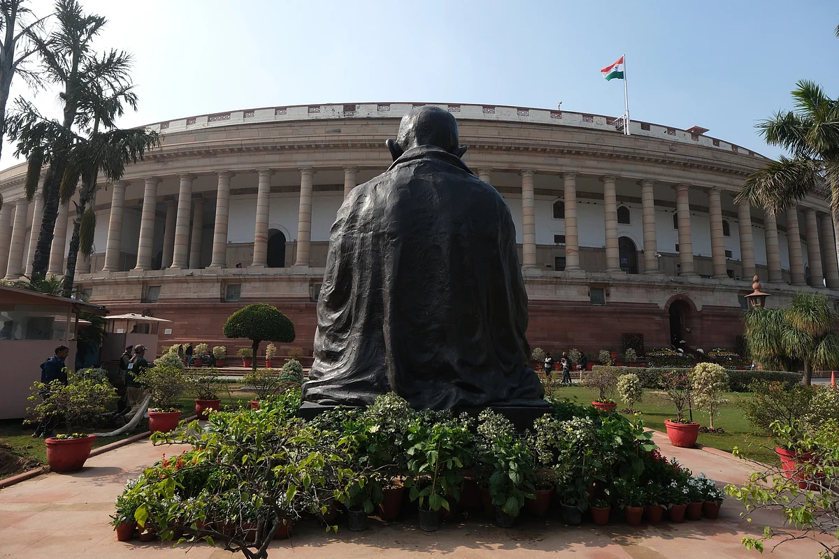 Statue of Mahatma Gandhi at the current parliament building in New Delhi in January. Photographer: T. Narayan/Bloomberg