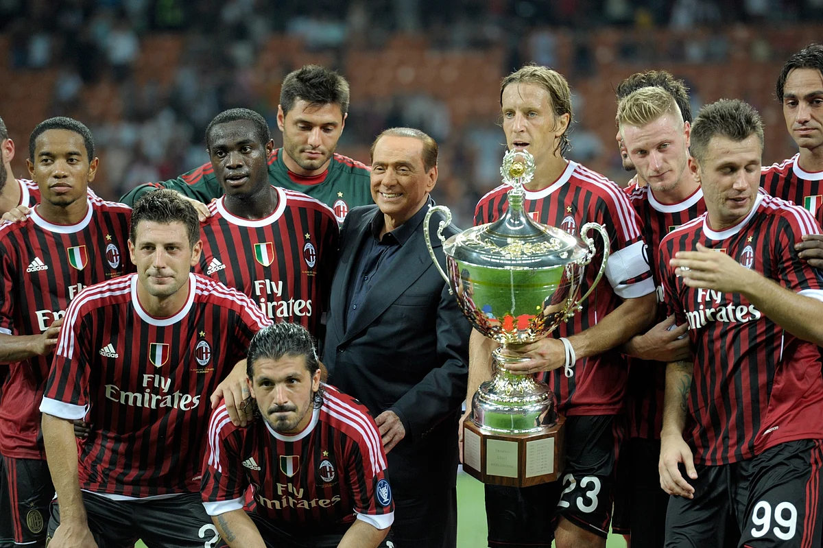With AC Milan players after winning the Berlusconi Trophy in 2011.Photographer: Claudio Villa/Getty Images