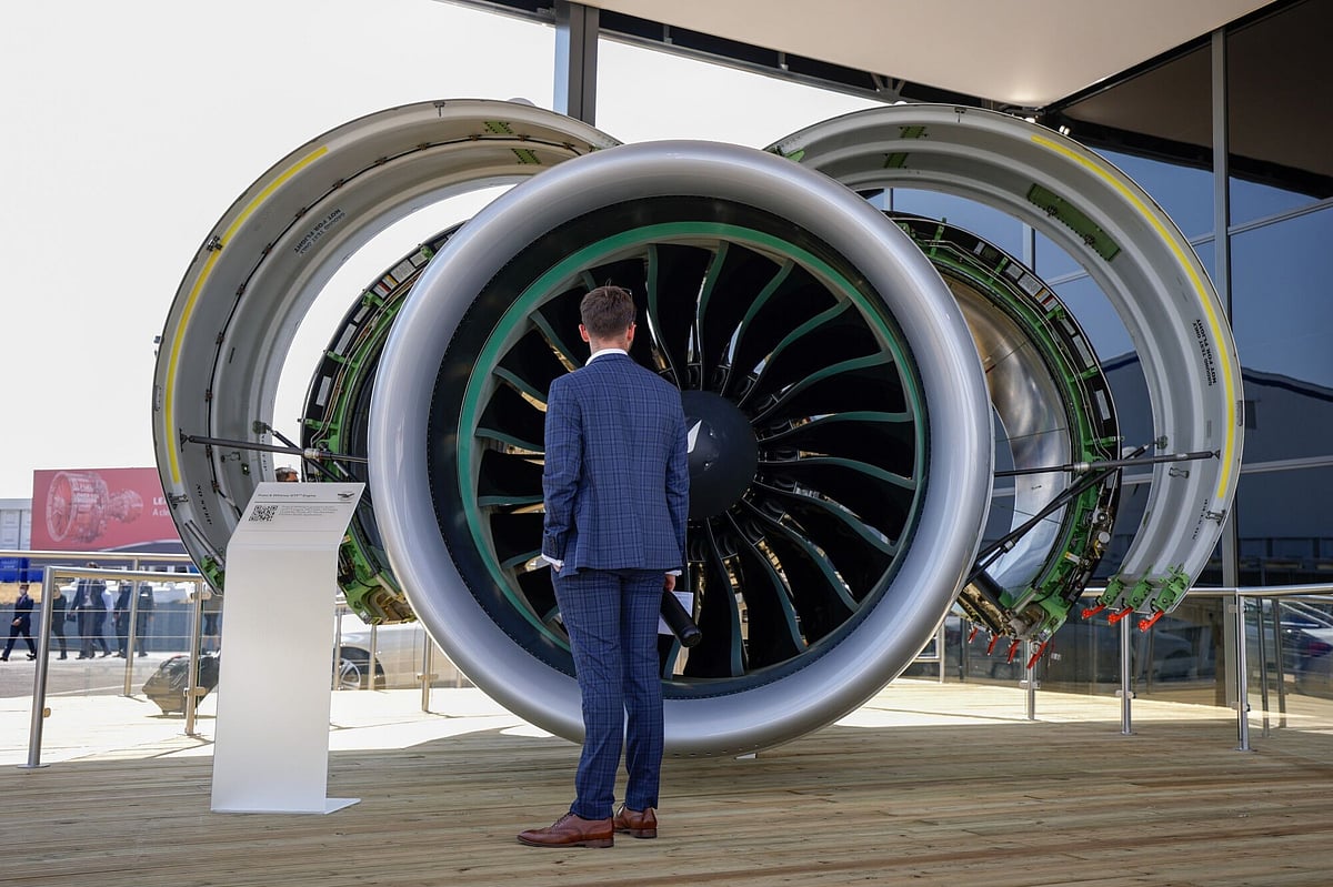 An attendee looks at a model of a Pratt & Whitney GTF engine on the opening day of the Farnborough International Airshow in Farnborough, UK, on Monday, July 18, 2022. The airshow, one of the biggest events in the global aerospace industry, runs through July 22.