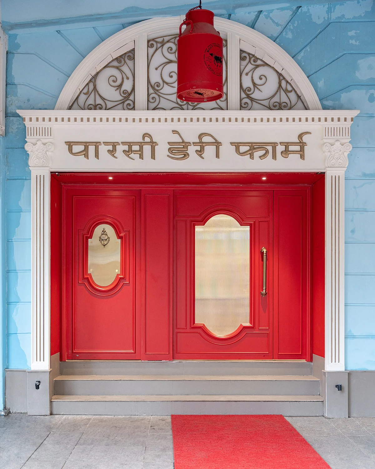 <div class="paragraphs"><p>The new fire engine red door at Parsi Dairy Farm in Mumbai's Marine Lines. </p></div>
