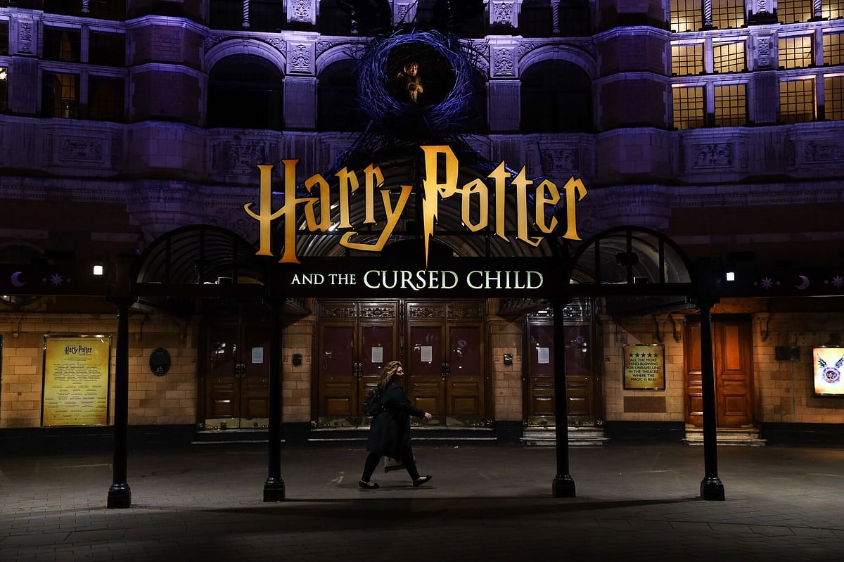 A pedestrian walks past the 'Harry Potter and the Cursed Child' show theatre in the West End district in London, U.K., on Friday, March 20, 2020. A shutdown of the U.K. capital would hit the night-time economy hard -- one in three employees in London works between 6 p.m. and 6 a.m., many in the pubs, restaurants and clubs most at risk of survival because of the pandemic.