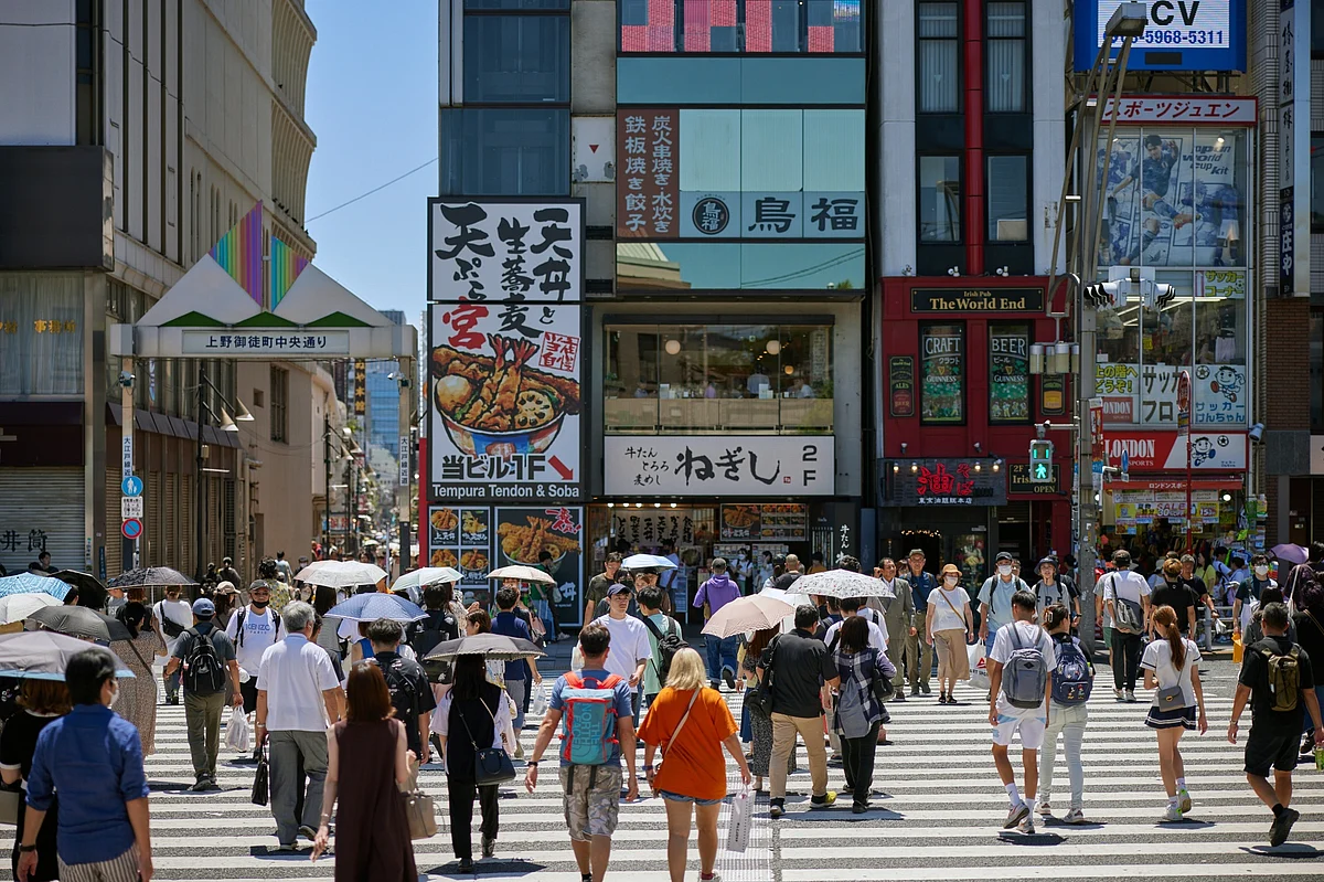 Pedestrians cross a street in Tokyo, Japan, on Sunday, July 30, 2023. Photographer: Shoko Takayasu/Bloomberg
