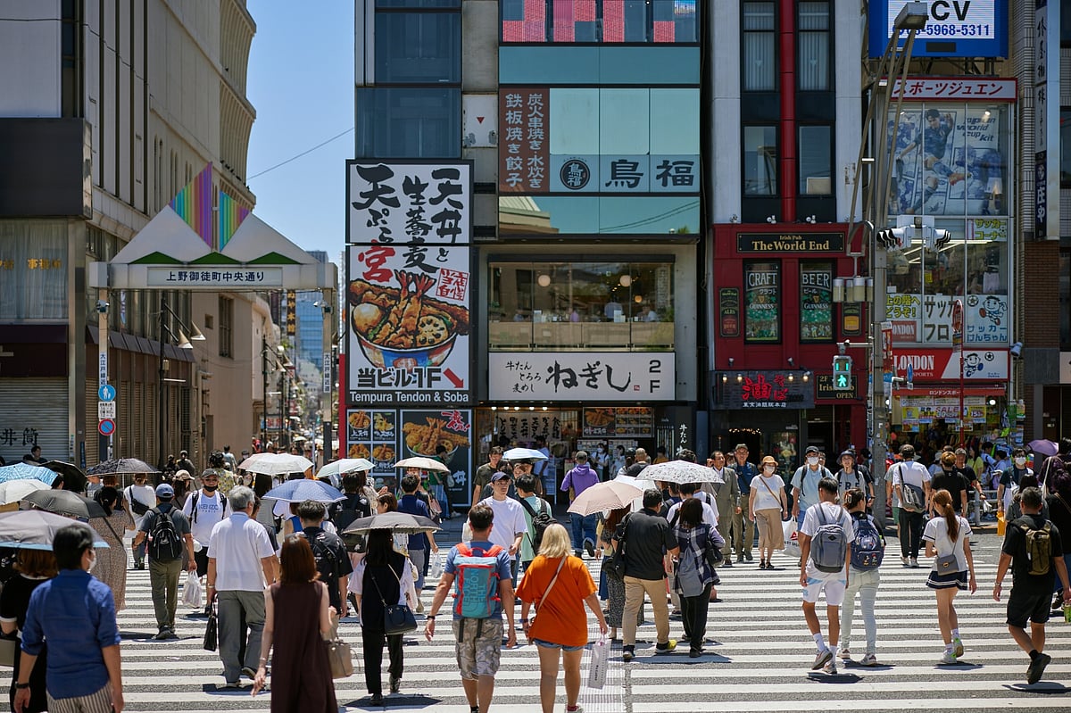 Pedestrians cross a street in Tokyo, Japan, on Sunday, July 30, 2023. Photographer: Shoko Takayasu/Bloomberg