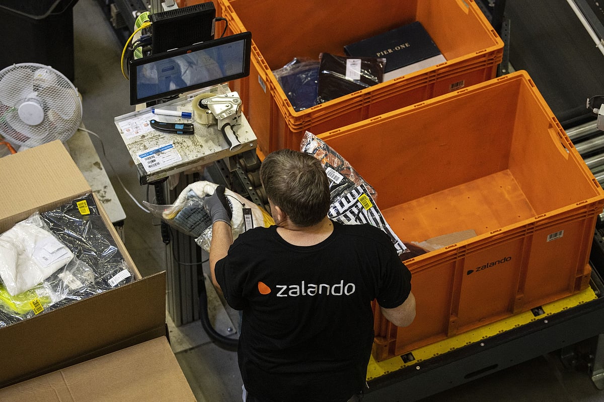 Garments sealed in plastic bags are packed for orders inside the Zalando SE fulfillment center in Erfurt, Germany.Photographer: Alex Kraus/Bloomberg