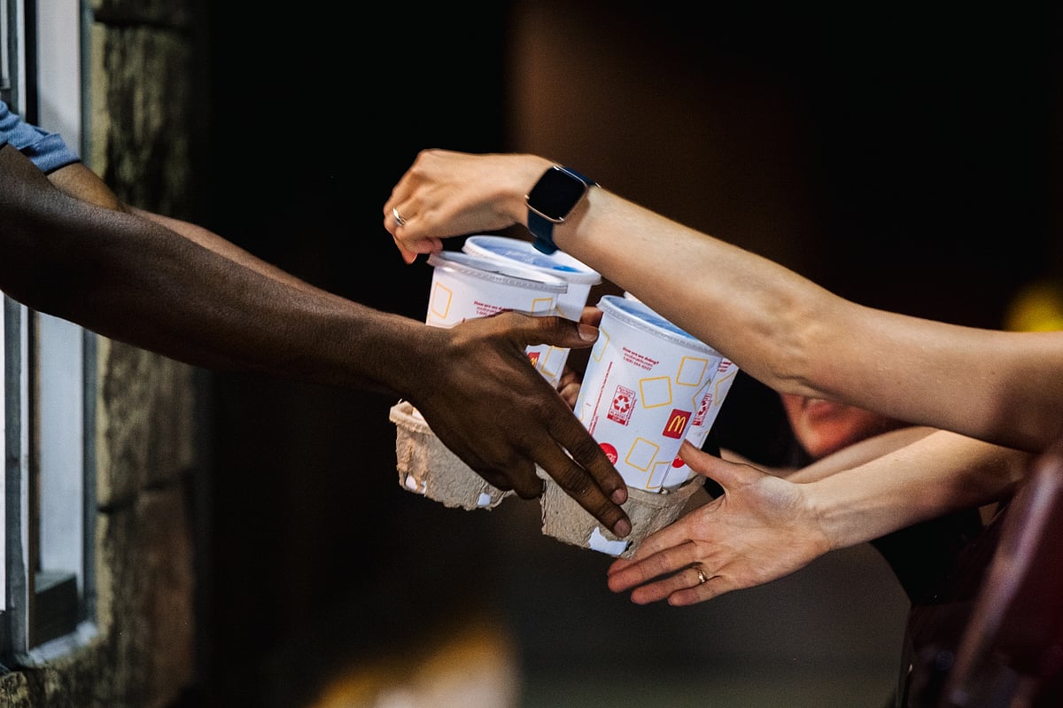 A McDonald’s employee hands a customer her food in a McDonald’s drive-thru in Houston, Texas. Photographer: Brandon Bell/Getty Images