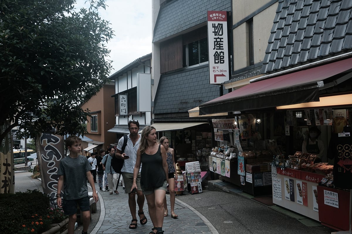 Visitors in front of a souvenir shop in Kanazawa.Photographer: Soichiro Koriyama/Bloomberg