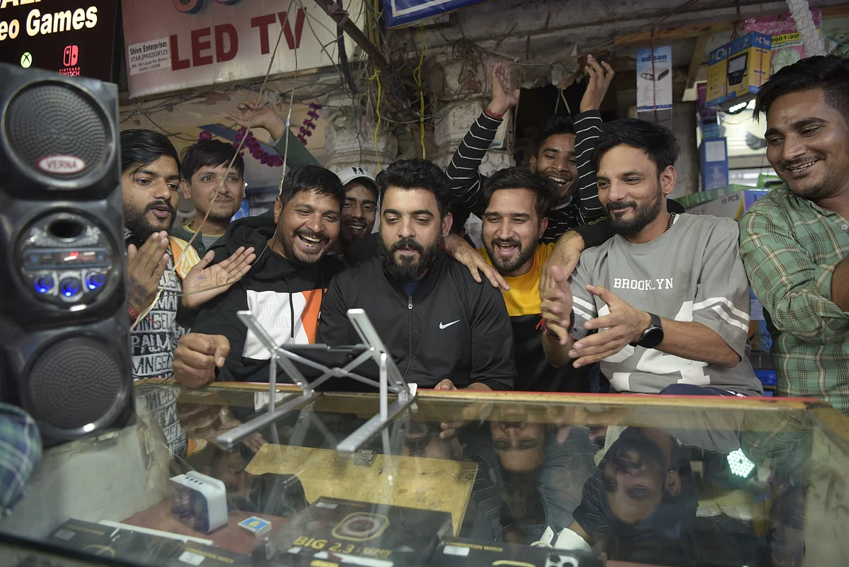 Spectators react as they watch the ICC Men’s Cricket World Cup 2023 final match between India and Australia, on a digital device at a store in Old Delhi, India, on Sunday, Nov. 19, 2023. Photographer: Saumya Khandelwal/Bloomberg