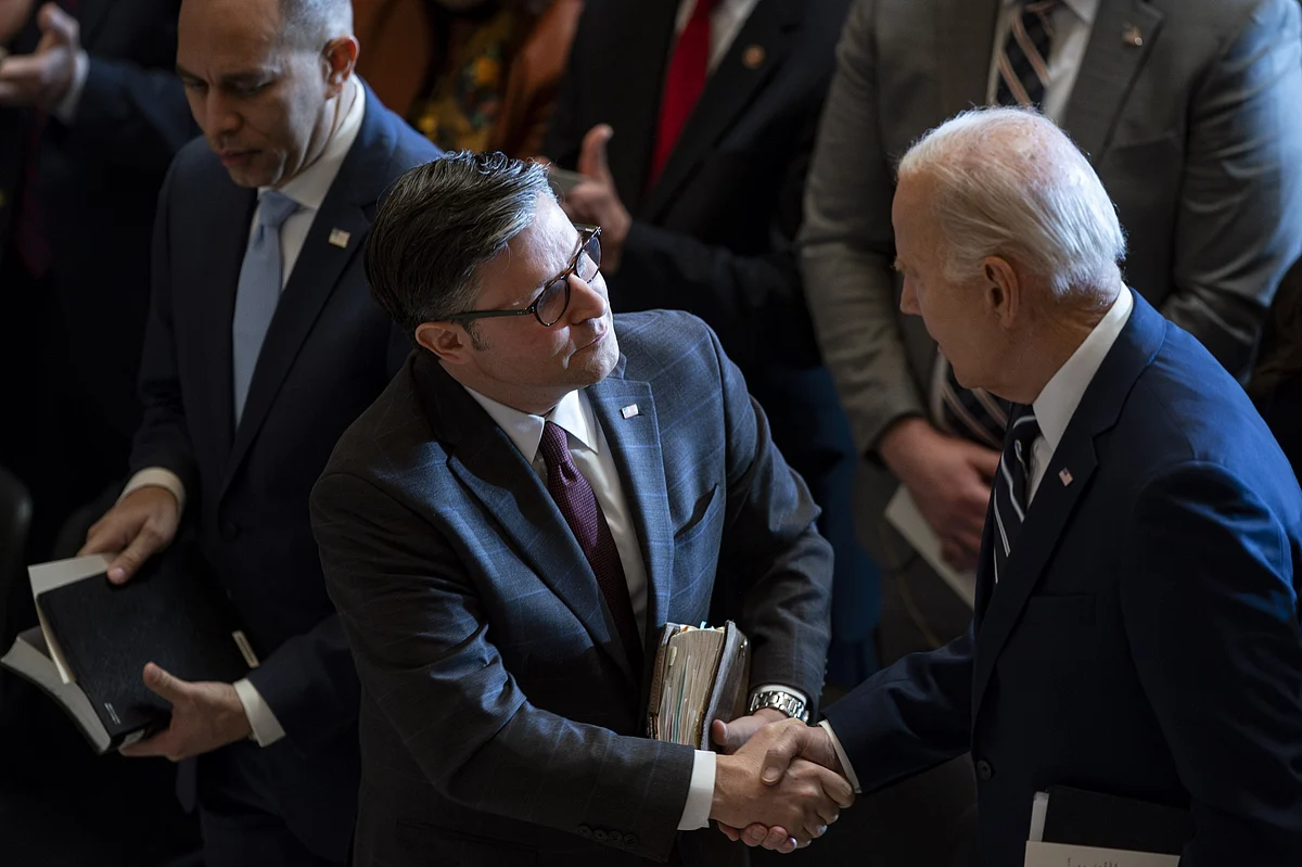 House Speaker Mike Johnson shakes hands with President Joe Biden, right, during the National Prayer Breakfast on Feb. 1. Photographer: Al Drago/Bloomberg