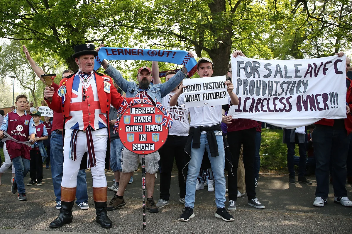 Aston Villa fans protest against owner Randy Lerner before a match in Birmingham in May 2016. Lerner sold the club following the team’s relegation from the Premier League that month.Photographer: James Baylis/AMA/Getty Images