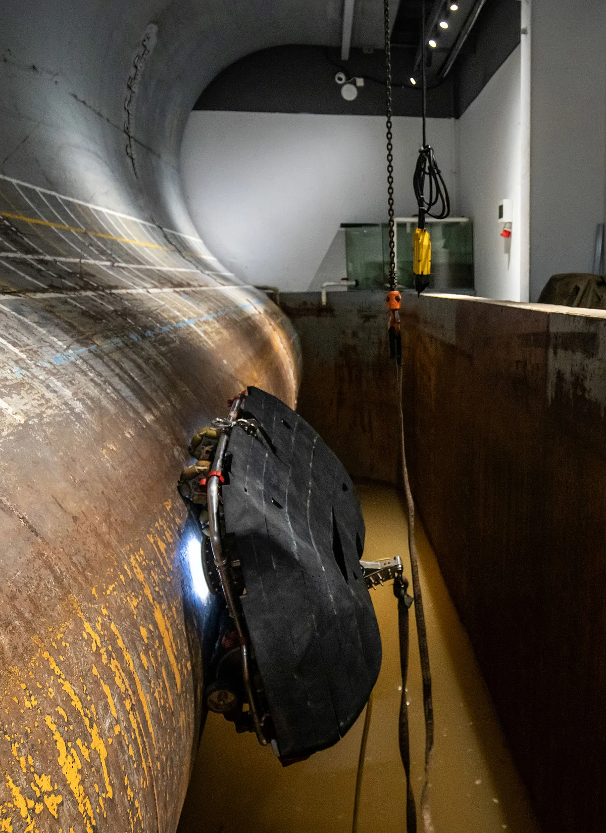 <div class="paragraphs"><p>A demo at the Neptune Robotics facility in Shenzhen shows one of the company's robots in a room built to simulate the curvature of a ship’s hull and muddy water conditions.</p></div>