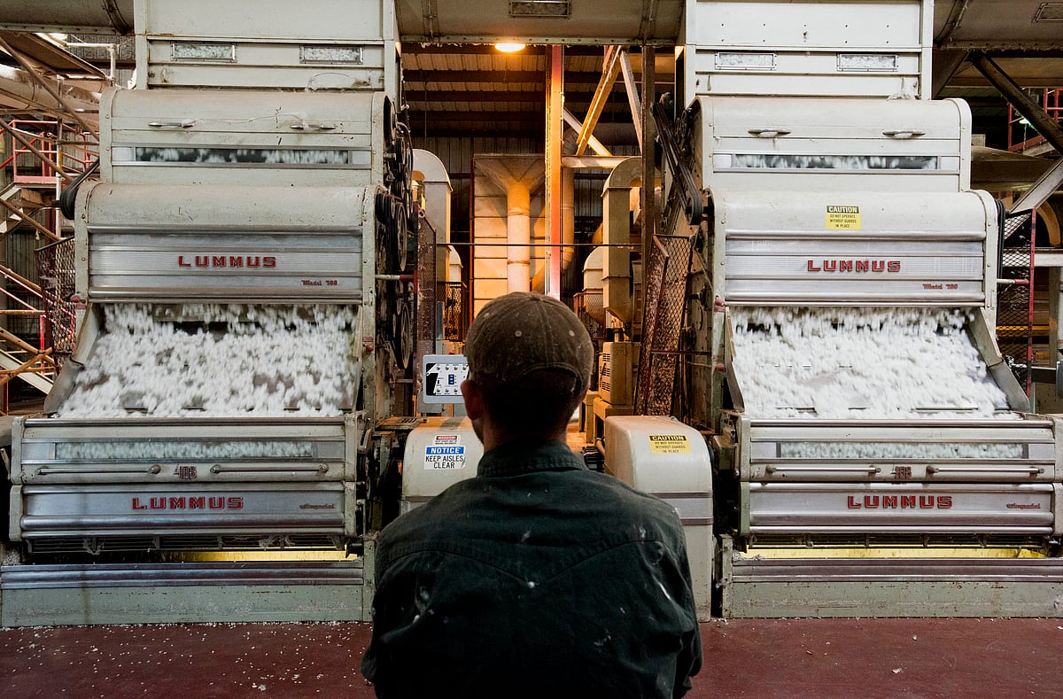 An employee watches over the cotton gin operation in East Carroll Parish, Louisiana, in 2013.Photographer: Ty Wright/Bloomberg