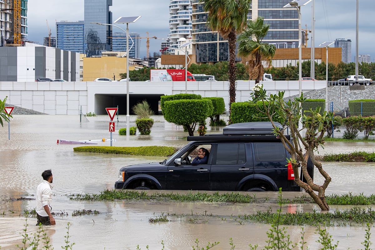 A motorist attempts to navigate flood waters in the Dubai Sports City district.Photographer: Christopher Pike/Bloomberg