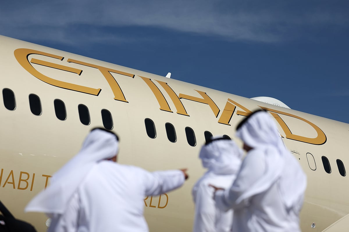 Visitors in front of a Boeing Co. 787-9 Dreamliner passenger aircraft, operated by Etihad Airways, at the Dubai Air Show in Dubai, United Arab Emirates, on Monday, Nov. 13, 2023. The 2023 Dubai Air Show kicked off on Monday with high expectations of large deals, continuing the prevailing theme of this year that’s seen airlines commit to huge orders. Photographer: Christopher Pike/Bloomberg