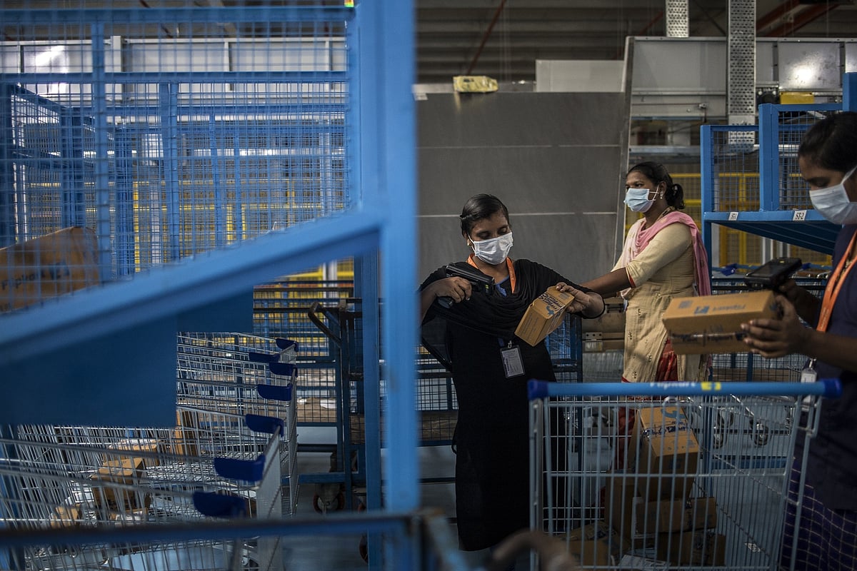 Workers scan packages&nbsp;at a Flipkart warehouse in Koduvalli, Thiruvallur, in the outskirts of Chennai, India.