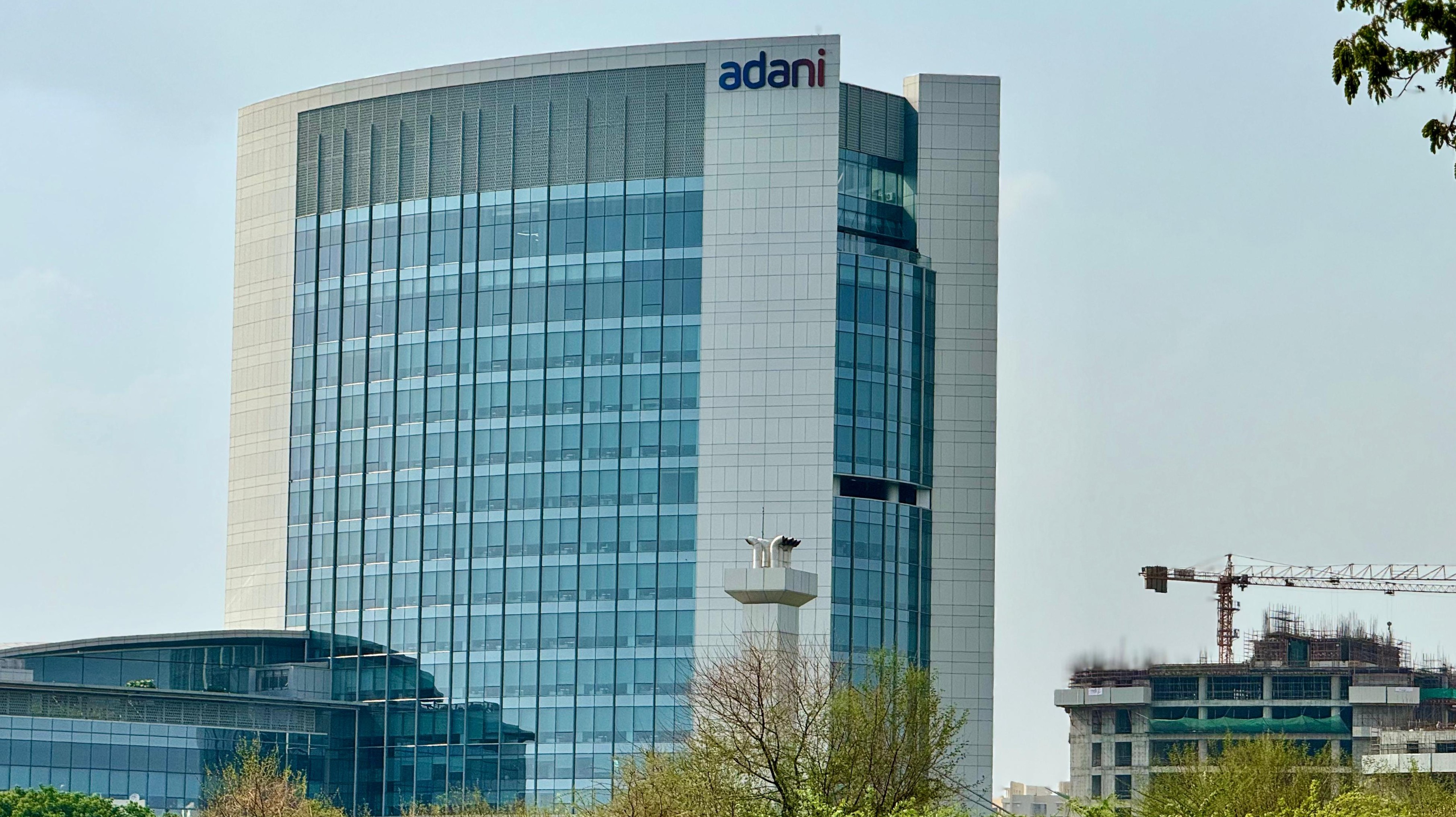 <div class="paragraphs"><p>Five international lenders including BNP Paribas, DBS Bank, Mizuho Bank, MUFG Bank, and Sumitomo Mitsui Banking Corporation participated in the initial financing.</p><p>(Adani Group's corporate office building in Ahmedabad. Photo: Vijay Sarpate/NDTV Profit)</p></div>