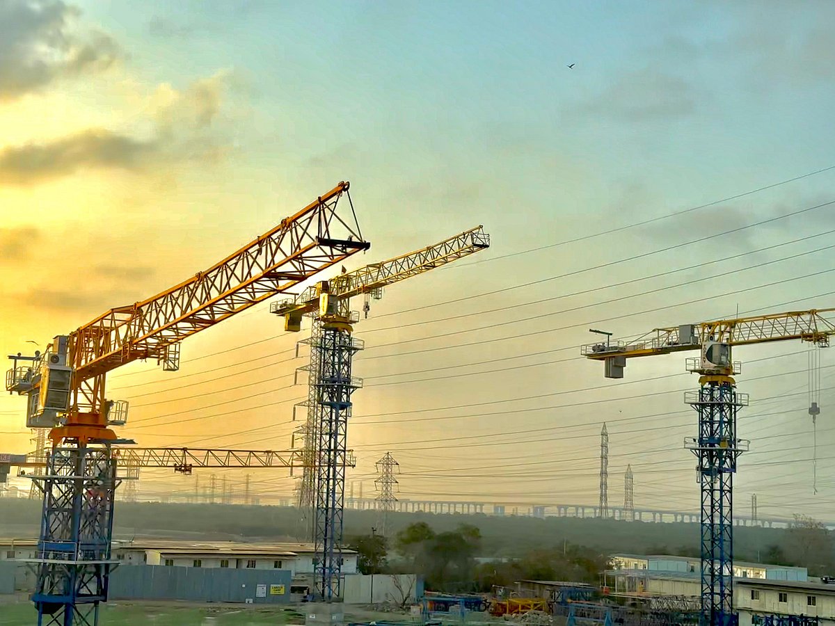 <div class="paragraphs"><p>Construction crane and power transmission towers seen against a backdrop of orange sky. (Photographer: Vishal Patel/ Source: NDTV Profit)</p></div>
