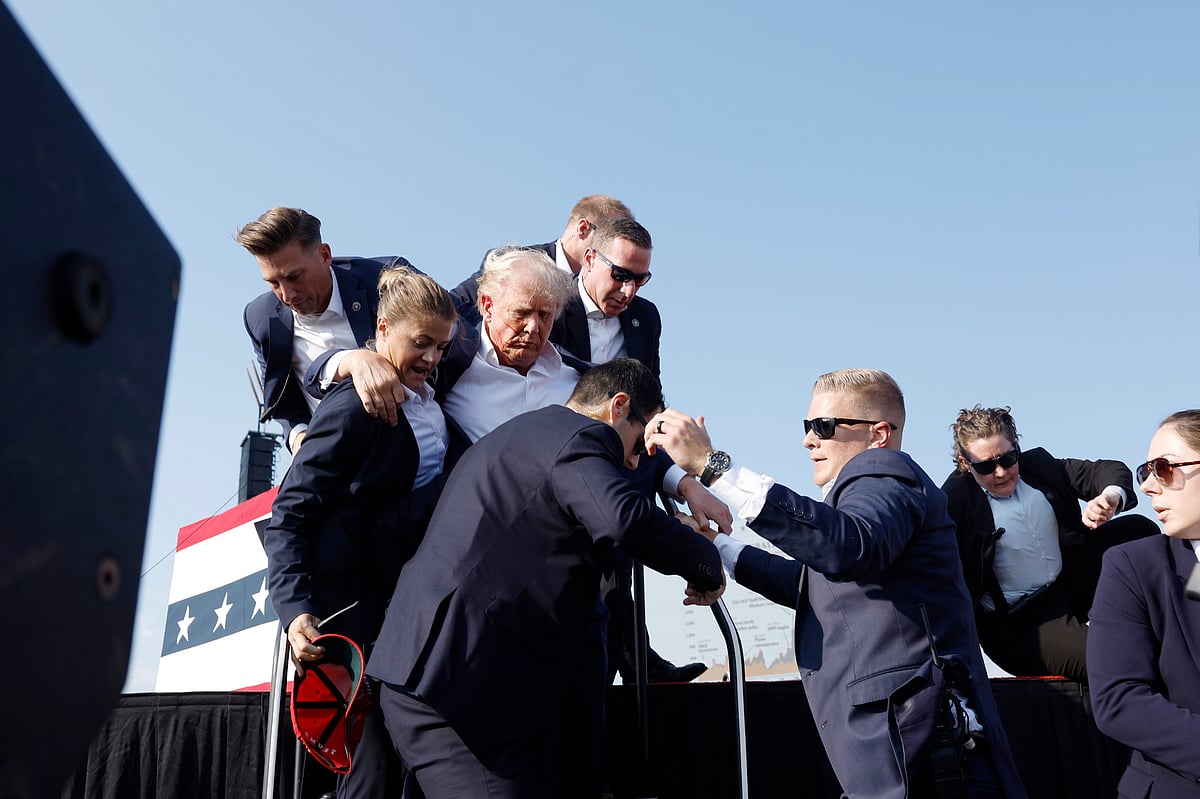 Secret Service agents rushed to the stage, yelling “get down” and formed a circle around the former president.Photographer: Anna Moneymaker/Getty Images  
