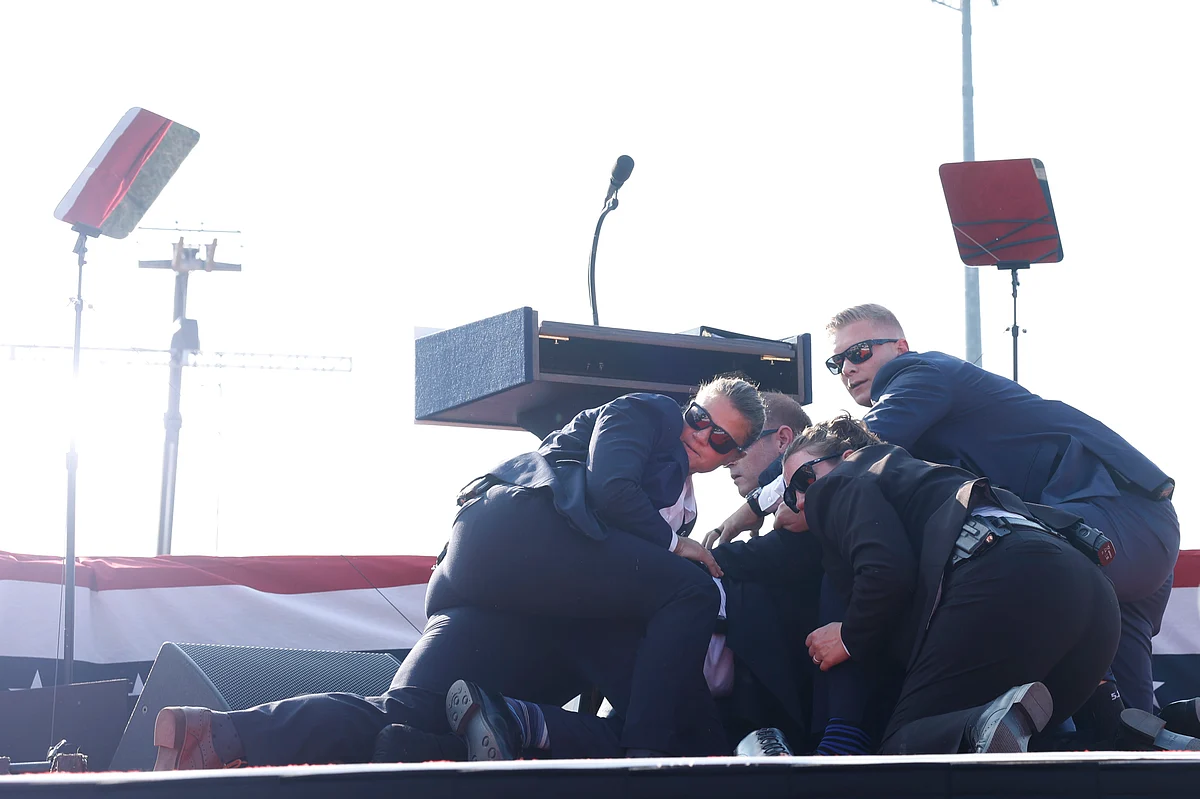 Secret Service agents rushed to the stage, yelling “get down” and formed a circle around the former president.Photographer: Anna Moneymaker/Getty Images