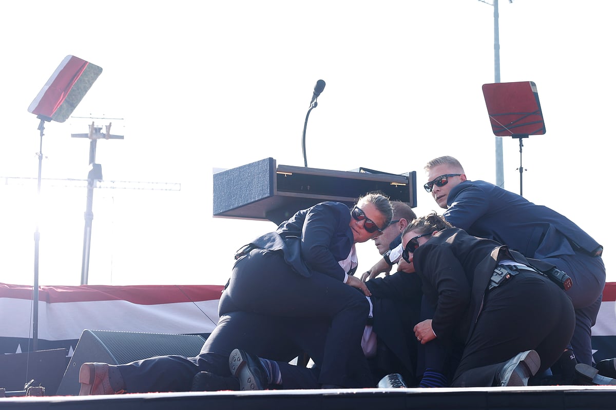 Secret Service agents rushed to the stage, yelling “get down” and formed a circle around the former president.Photographer: Anna Moneymaker/Getty Images 