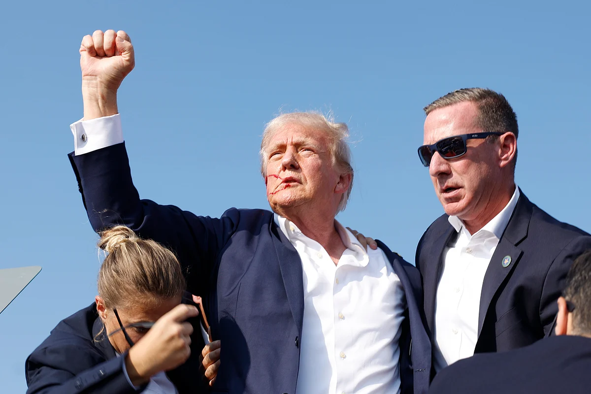 Trump pumped his fist in the air and waved to the crowd before exiting the stage in a ring of agents.Photographer: Anna Moneymaker/Getty Images