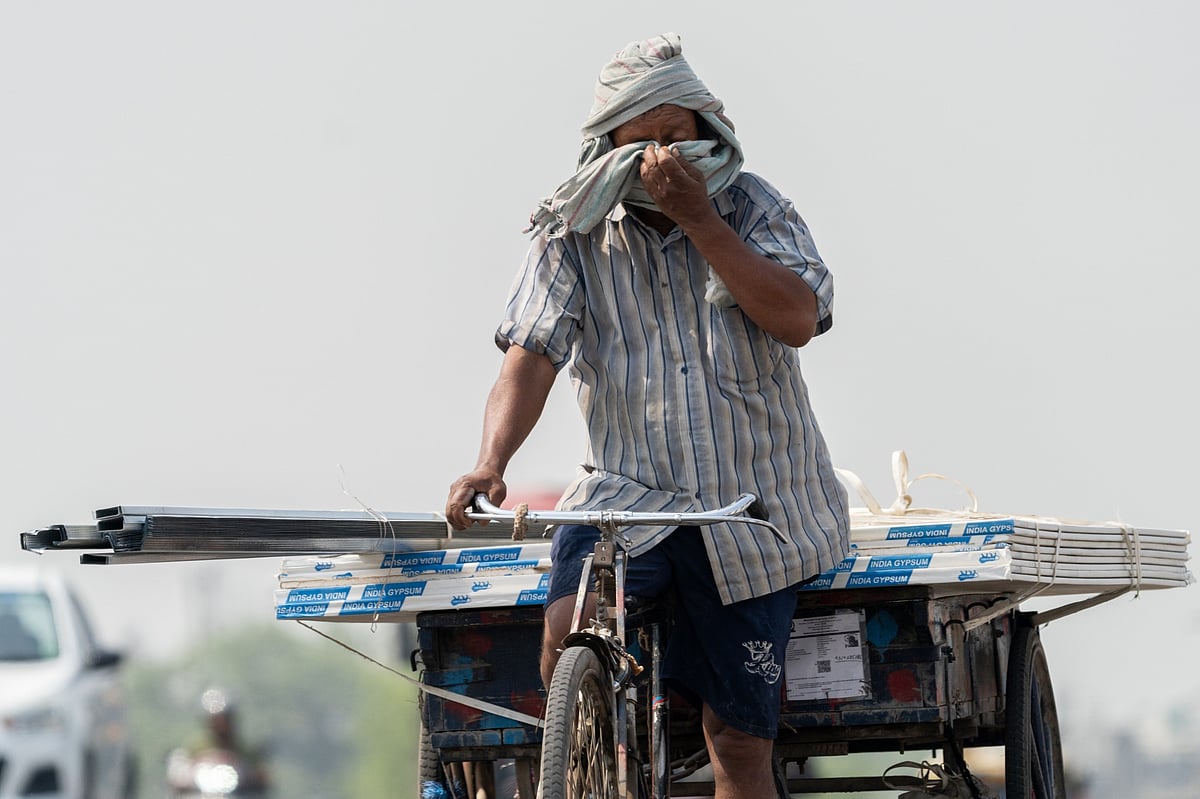 A rickshaw rider wipes his face during high temperatures in New Delhi in May.Photographer: Anindito Mukherjee/Bloomberg