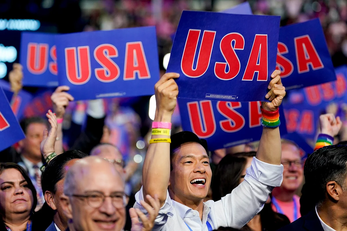 Delegates hold signs during the DNC on Aug. 21.Photographer: Al Drago/Bloomberg