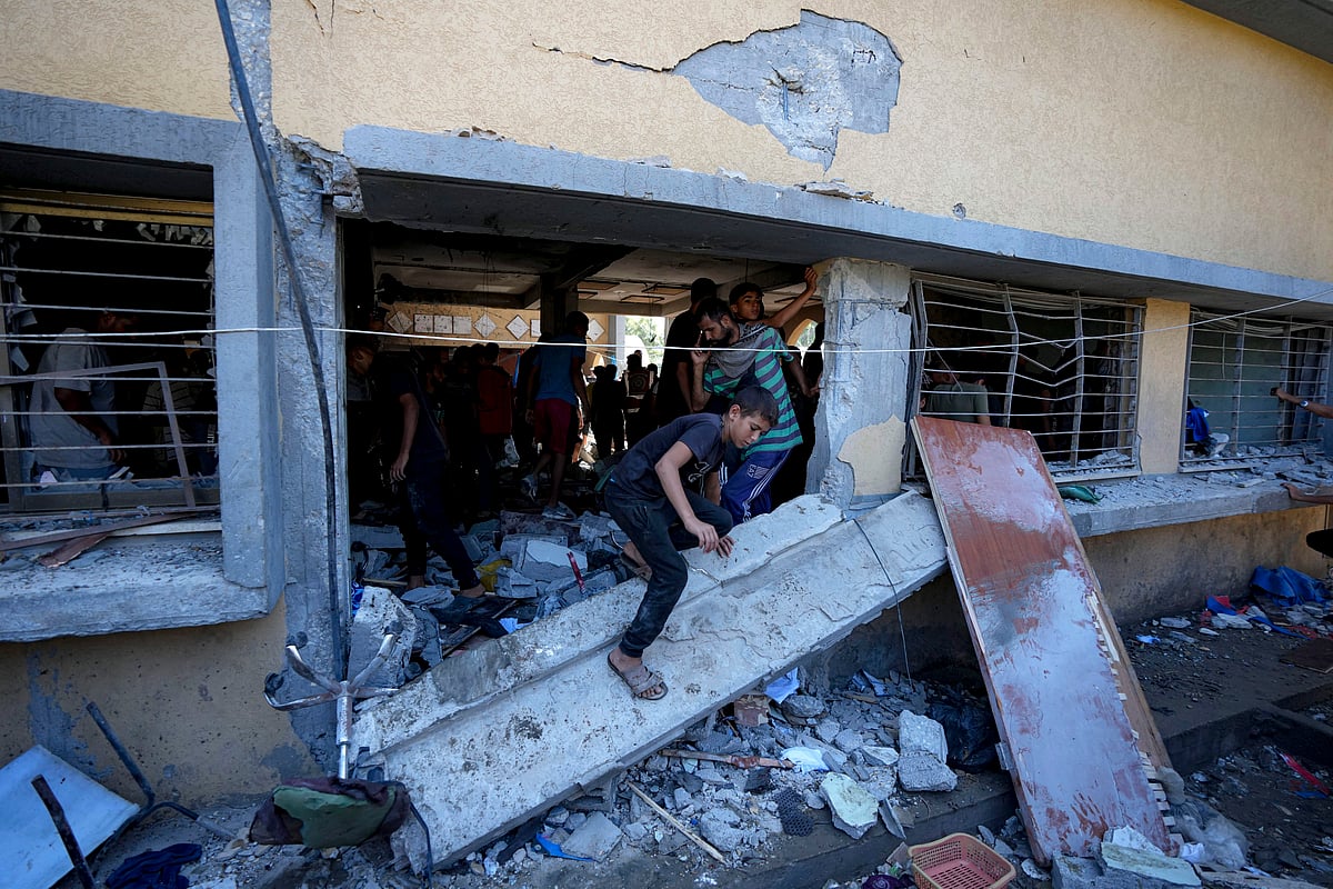<div class="paragraphs"><p>Palestinians search for the bodies of their relatives killed in an Israeli bombardment of a school in Deir al-Balah, central Gaza Strip, Thursday, Oct. 10. (Source: PTI)</p></div>
