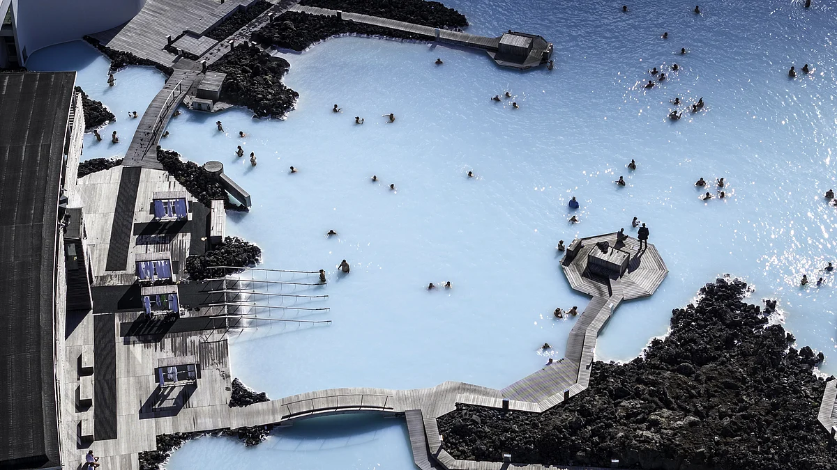 <div class="paragraphs"><p>Tourists bathe at the Blue Lagoon geothermal spa near Grindavik, Iceland. Wellness tourism and spas are two categories in the report. Photographer: John Moore/Getty Images</p></div>