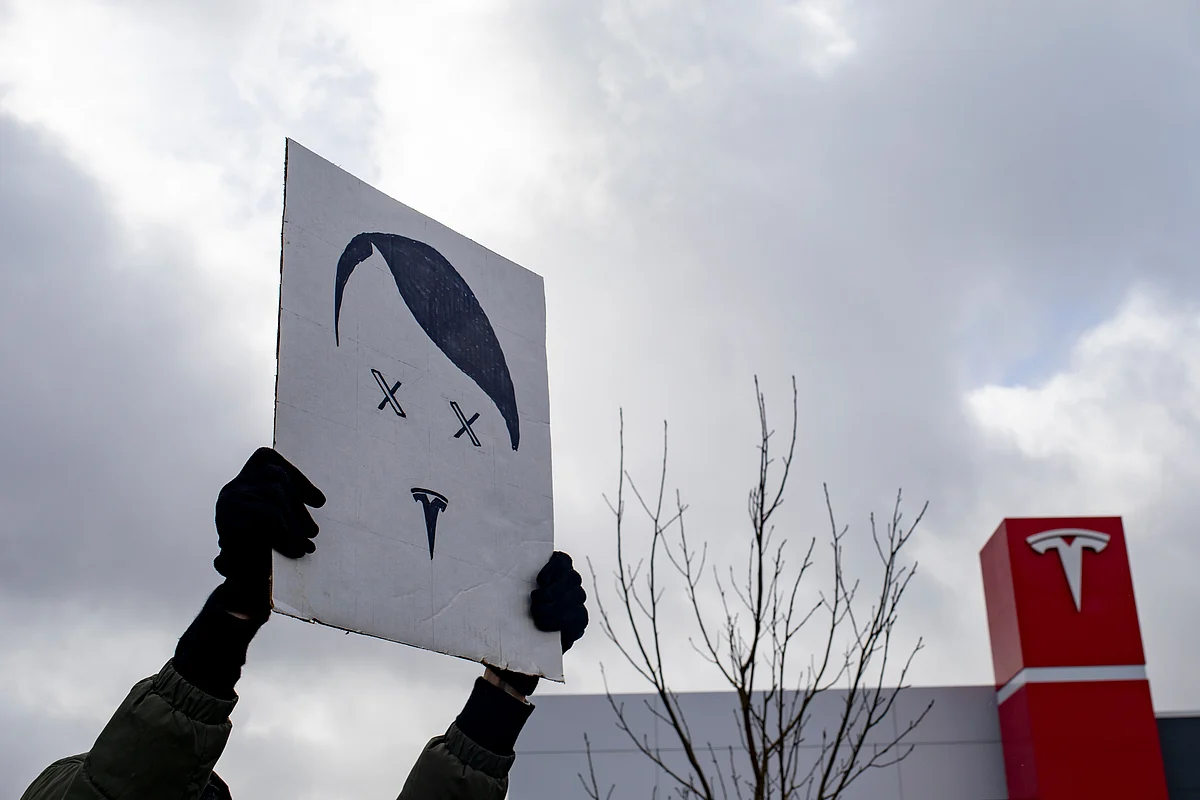 <div class="paragraphs"><p>A protester holds a sign during a rally against Elon Musk’s role in the Trump administration outside a Tesla showroom in Michigan on March 20. (Photographer: Emily Elconin/Bloomberg)</p></div>