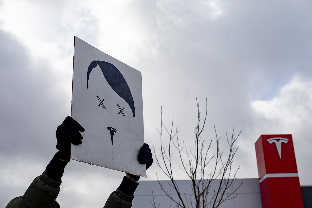 <div class="paragraphs"><p>A protester holds a sign during a rally against Elon Musk’s role in the Trump administration outside a Tesla showroom in Michigan on March 20. (Photographer: Emily Elconin/Bloomberg)</p></div>