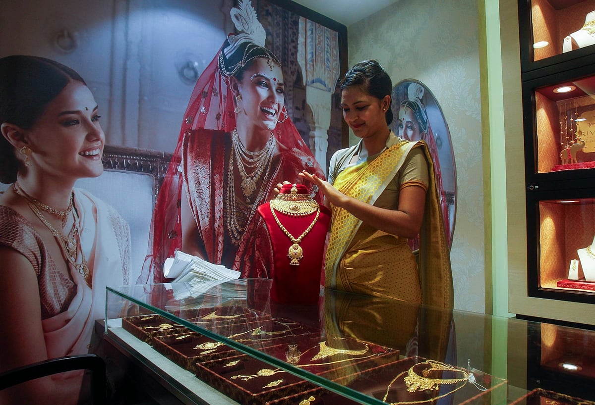 <div class="paragraphs"><p>Agartala: An employee displays a gold necklace at a jewellery showroom  in Agartala. (PTI Photo)</p></div>