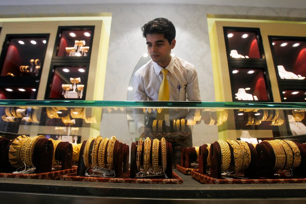 <div class="paragraphs"><p>Agartala: An employee displays gold ornaments at a jewellery showroom. (Photo: PTI)</p></div>