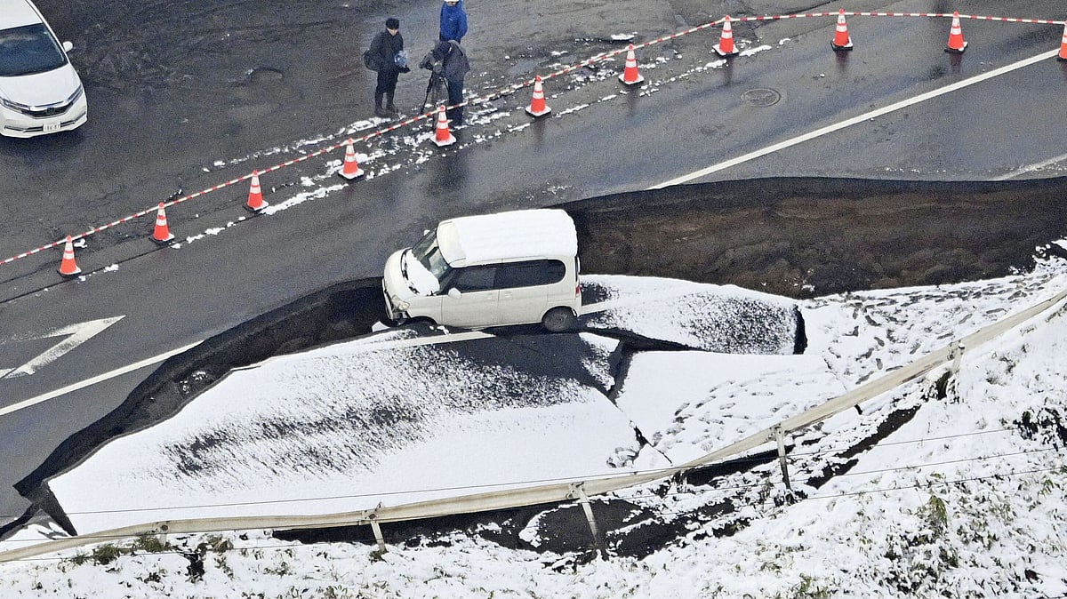<div class="paragraphs"><p>This aerial photo shows a vehicle sitting on a damaged road in Tohoku town, Aomori prefecture, northern Japan on Tuesday, Dec. 9, 2025, following a powerful earthquake on late Monday. (Photo: AP/PTI)<br> </p></div>