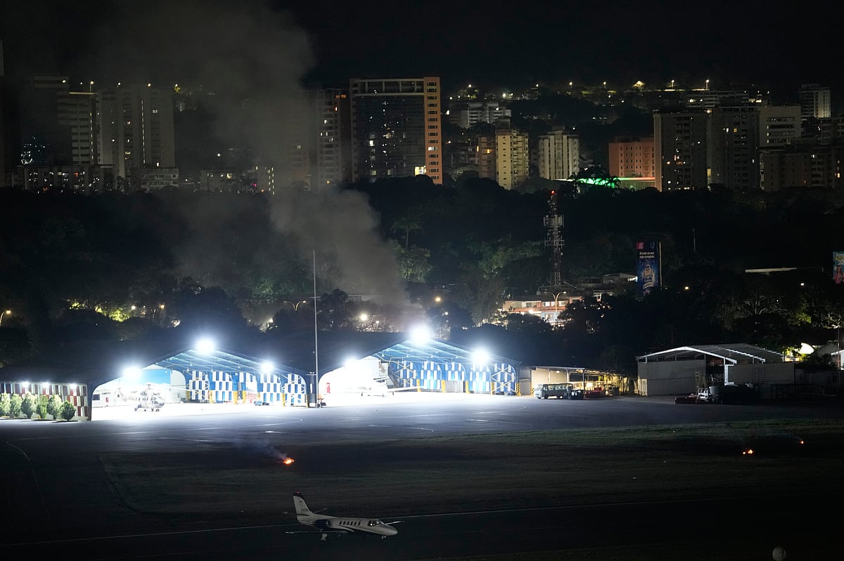 <div class="paragraphs"><p>Smoke rises at La Carlota airport after explosions and low-flying aircraft were heard in Caracas, Venezuela, Saturday, Jan. 3, 2026. (Photo: AP/PTI)</p></div>