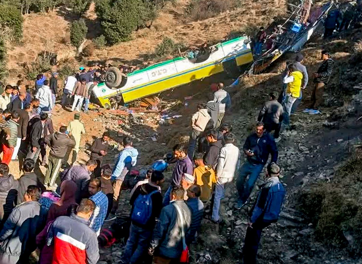 <div class="paragraphs"><p>People gather around a private bus that rolled down into a deep gorge, in Sirmaur district, Himachal Pradesh, Friday, Jan. 9, 2026.  (PTI Photo)</p></div>