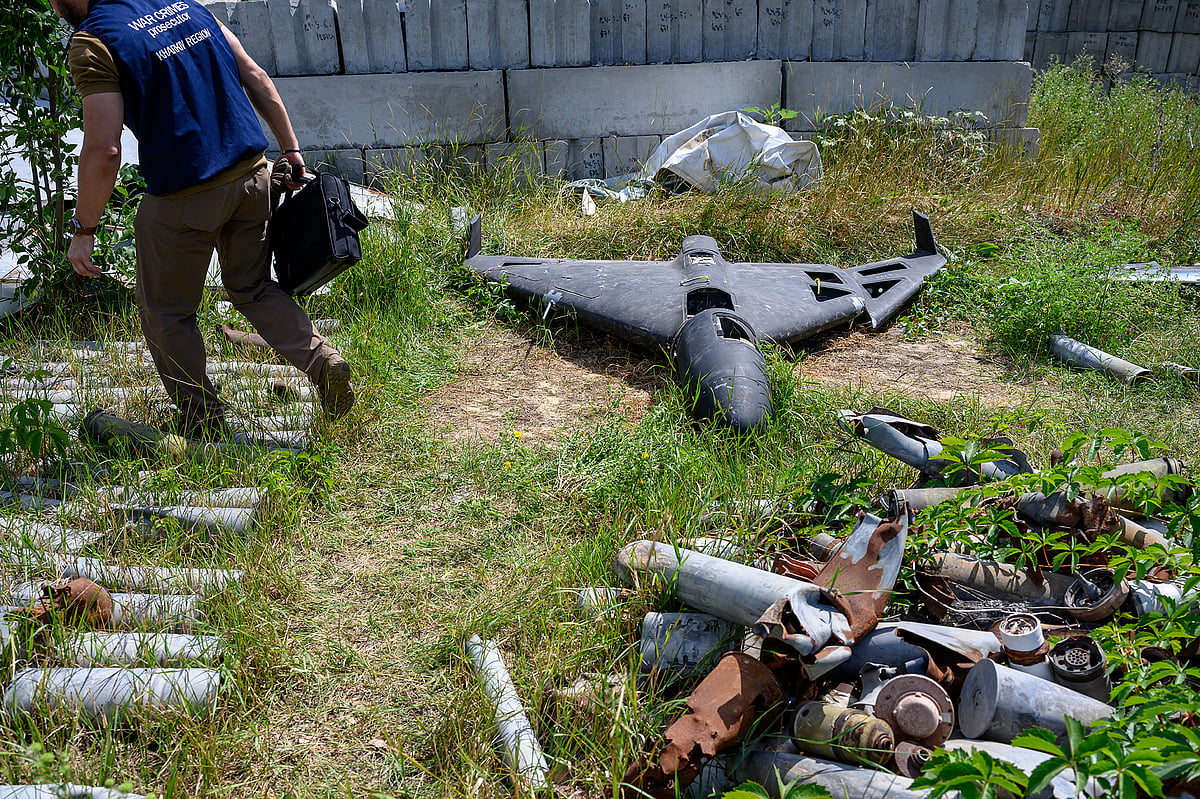 <div class="paragraphs"><p>A war crimes prosecutor stands beside the remains of a Russian-made, Iran-designed Shahed-136 drone, known as a Geran-2 in Russia in Kharkiv, Ukraine on on July 30. (Photographer: Scott Peterson/Getty Images via Bloomberg)</p></div>
