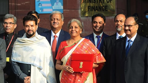  The finance minister with team on Budget Day. Will the smiles last? 