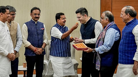 Sweet moment of defection: AAP rebels with BJP leaders