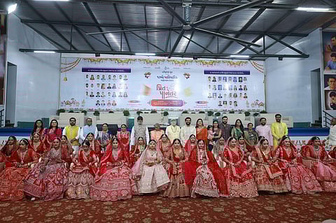 Savjibhai Dholakia and the Dholakia family share a heartfelt moment with 28 brides-to-be.