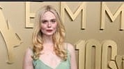 Elle Fanning wears Cartier Collection pendant ear clips and a Cartier Essential Lines bracelet.
