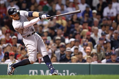 BOSTON, MASSACHUSETTS - SEPTEMBER 13: Aaron Judge #99 of the New York Yankees hits a home run against the Boston Red Sox during the eighth inning at Fenway Park on September 13, 2022 in Boston, Massachusetts.   Maddie Meyer/Getty Images/AFP (Photo by Maddie Meyer / GETTY IMAGES NORTH AMERICA / Getty Images via AFP)