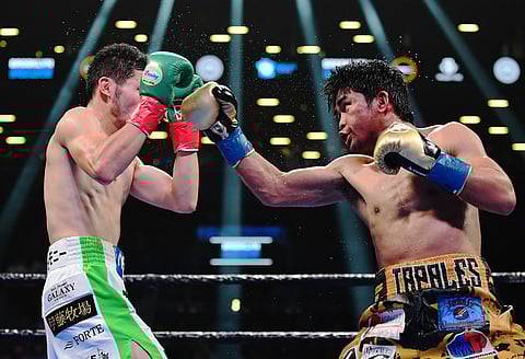EMILEE CHINN/AGENCE FRANCE-PRESSE
Marlon Tapales (right) mixes it up with Japanese Ryosuke Iwasa in their December 2019 clash at the Barclays Center in Brooklyn, New York. Tapales is back in the United States to begin training for a possible world title shot.
