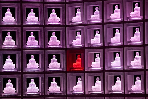 This picture shows the Ruriden facility, an octagon-shaped space with walls of floor-to-ceiling displaying glass Buddha statuettes symbolising individuals whose ashes are stored there, at the Kokokuji Buddhist temple in Tokyo. Photo by Behrouz MEHRI / AFP
