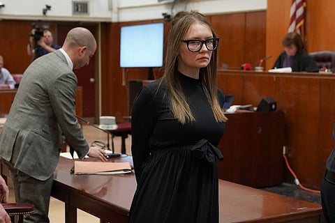 In this file photo, fake German heiress Anna Sorokin is led away after being sentenced in Manhattan Supreme Court on 9 May 2019  following her conviction on multiple counts of grand larceny and theft of services. (Photo by TIMOTHY A. CLARY / AFP)