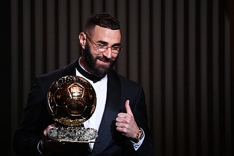 Real Madrid's French forward Karim Benzema receives the Ballon d'Or award during the 2022 Ballon d'Or France Football award ceremony at the Theatre du Chatelet in Paris on October 17, 2022. (Photo by FRANCK FIFE / AFP)