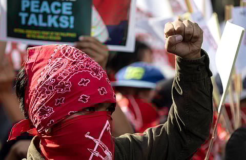 Members of the Philippine communist movement hold a lightning protest in Manila on 25 March 2019. The group called for the resumption of peace talks with the government.