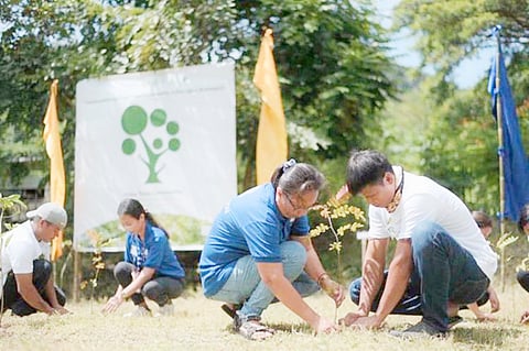 FR Foundation Secretary-General Yoshio Ishida (right) plants flowering trees at the launch of Grow Trees Community in Nasugbu, Batangas. | PHOTOGRAPH COURTESY OF SM