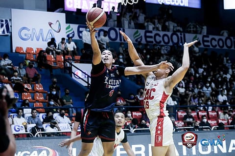 LETRAN’s Paolo Javillonar (left) scores off Emilio Aguinaldo College defender Nat Cosejo during NCAA action at the FilOil EcoOil Centre Saturday. | Photograph COURTESY OF NCAA