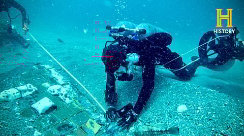 UNDERWATER explorer and marine biologist Mike Barnette and wreck diver Jimmy Gadomski (partly hidden) explore a 20-foot segment of the 1986 Space Shuttle Challenger discovered in the waters off the coast of Florida during the filming of the new series ‘The Bermuda Triangle: Into Cursed Waters.’ | The History Channel/Agence france-presse